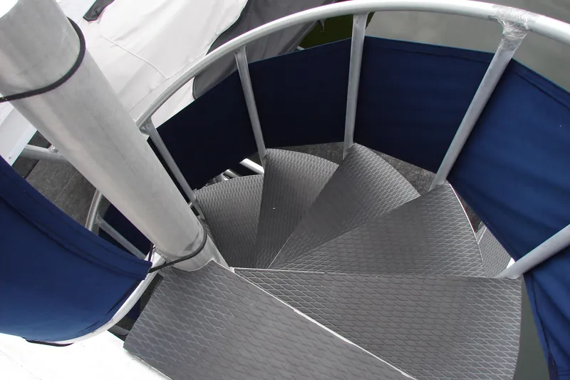 Slide: The Image of Spiral staircase on 1999 Sumerset 18x90 houseboat with blue railing. - 31