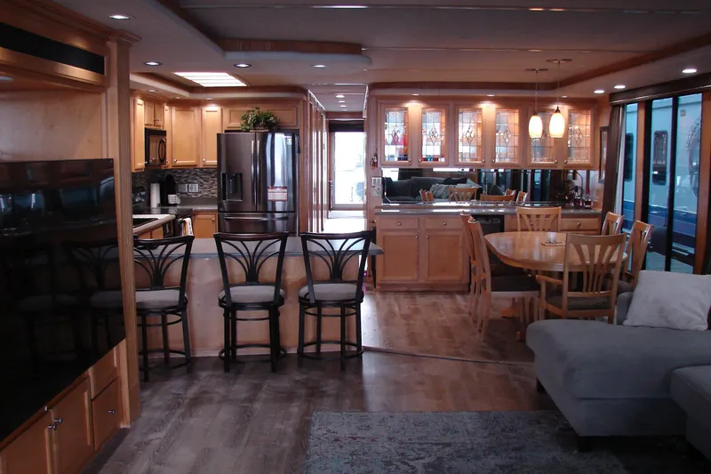 Slide: The Image of Luxurious interior of a 1999 Sumerset 18x90 houseboat with modern kitchen and dining area. - 8
