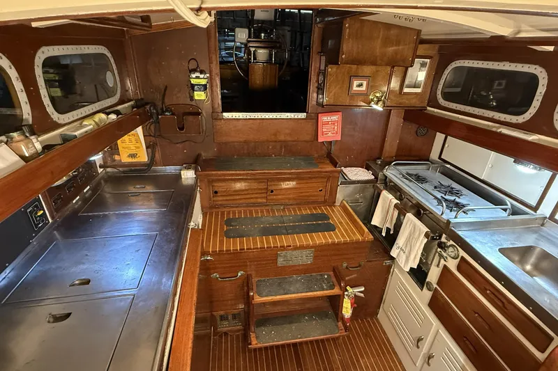 Slide: The Image of Vintage 1959 Sparkman & Stephens Custom 46 yacht galley with wood cabinetry and stainless steel appliances. - 14