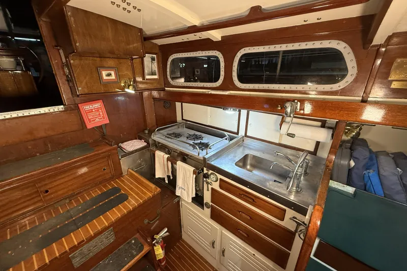 Slide: The Image of 1959 Sparkman & Stephens Custom 46 yacht interior with wooden cabinetry and stainless steel kitchen. - 15