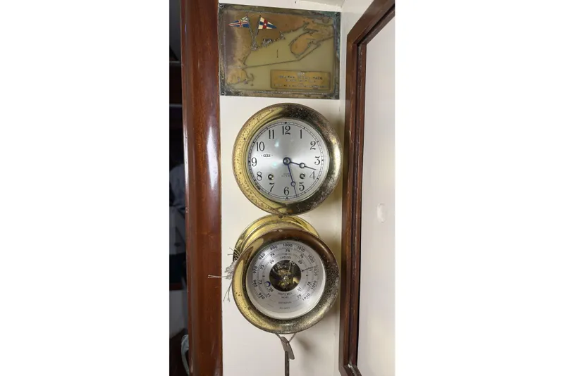 Slide: The Image of Vintage clock and barometer on 1959 Sparkman & Stephens Custom 46 yacht interior. - 19