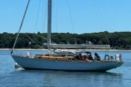 Slide: The Image of Sailing yacht Sparkman & Stephens Custom 46, 1959, on calm water with forested shoreline. - 2
