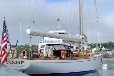 Slide: The Image of 1959 Sparkman & Stephens Custom 46 sailboat docked with American flag. - 7