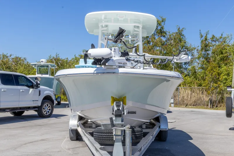 Slide: The Image of 2022 Crevalle 24 HCO boat on trailer, parked outdoors with clear blue sky. - 10