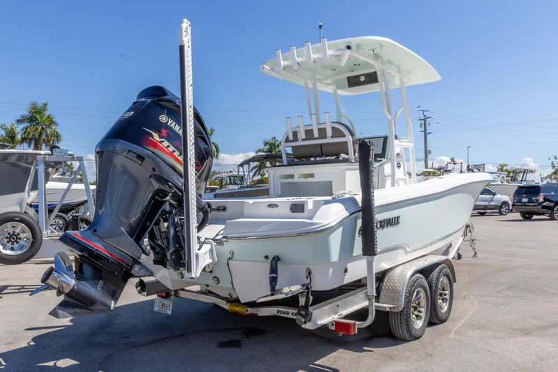Slide: The Image of 2022 Crevalle 24 HCO boat with Yamaha engine on trailer, parked outdoors. - 13