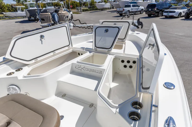 Slide: The Image of 2022 Crevalle 24 HCO boat with open storage compartments and seating area. - 8