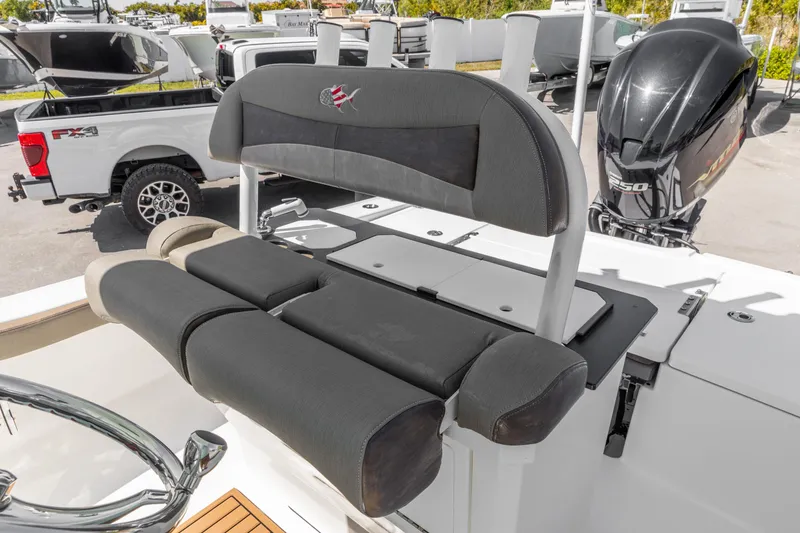 Slide: The Image of 2022 Crevalle 24 HCO boat with cushioned seating and powerful outboard motor. - 9