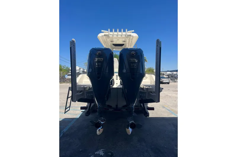 Slide: The Image of 2026 Blackwood 270 boat with dual 300 V6 outboard engines, parked outdoors. - 2