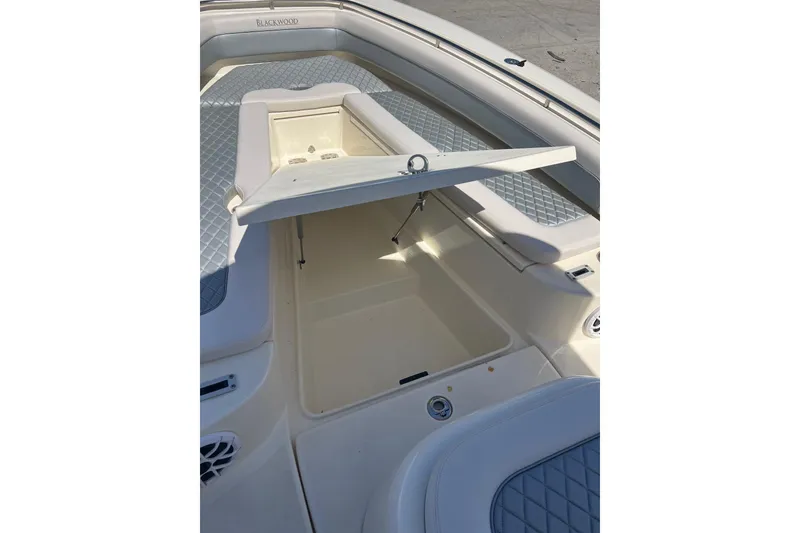 Slide: The Image of 2026 Blackwood 270 boat interior with open storage compartment and cushioned seating. - 6