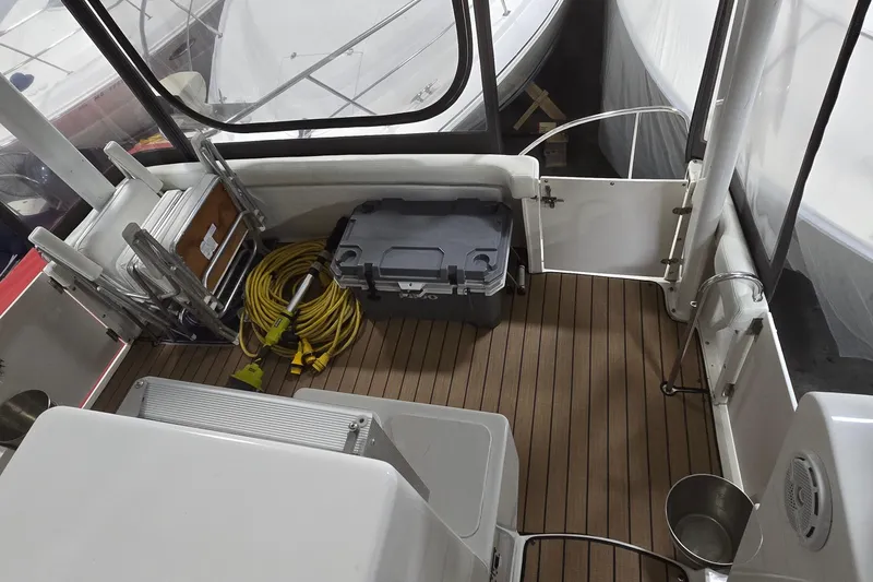 Slide: The Image of 1998 Silverton 322 Motor Yacht deck with storage box and coiled yellow cable. - 13