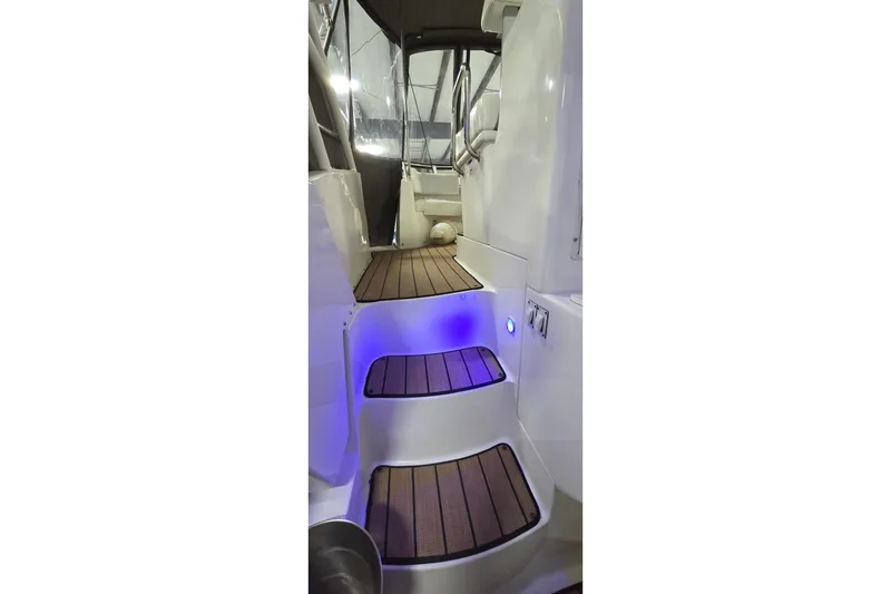 Slide: The Image of 1998 Silverton 322 Motor Yacht interior stairs with blue LED lighting. - 14