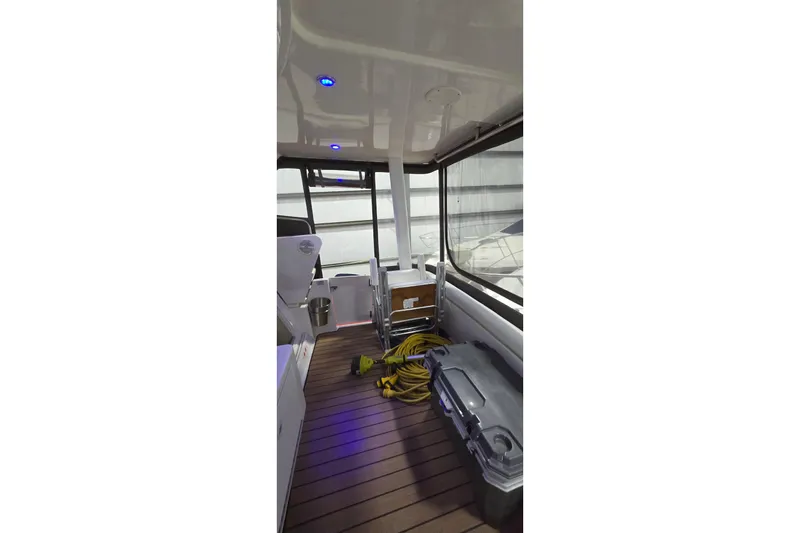 Slide: The Image of 1998 Silverton 322 Motor Yacht interior with wood flooring and blue lighting. - 15