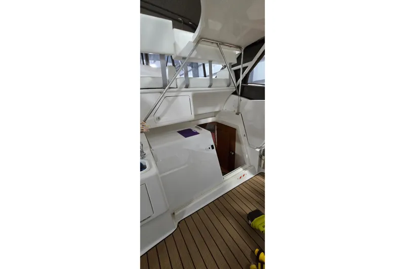 Slide: The Image of 1998 Silverton 322 Motor Yacht interior with white cabinetry and wooden flooring. - 18