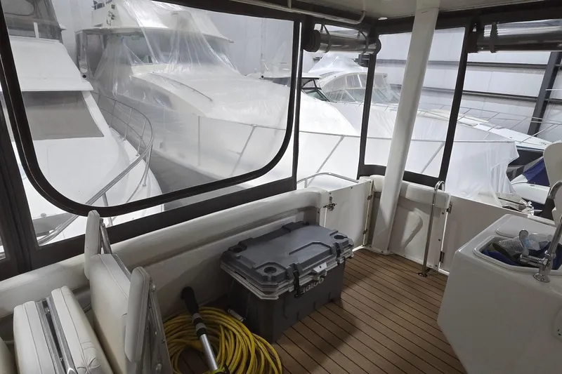 Slide: The Image of 1998 Silverton 322 Motor Yacht interior with docked boats visible through windows. - 19