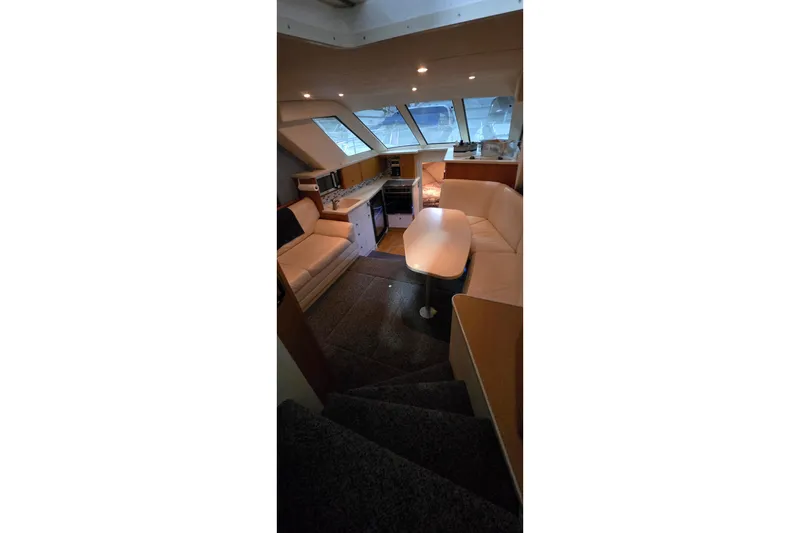 Slide: The Image of Interior of 1998 Silverton 322 Motor Yacht with seating and kitchenette. - 22