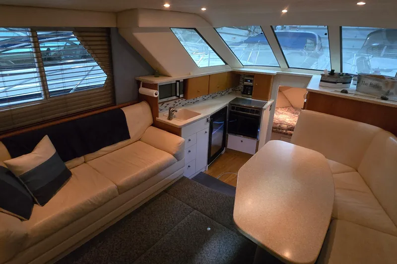 Slide: The Image of Interior of 1998 Silverton 322 Motor Yacht with cozy seating and kitchenette. - 23