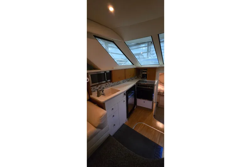 Slide: The Image of Interior of 1998 Silverton 322 Motor Yacht with modern kitchen amenities. - 24