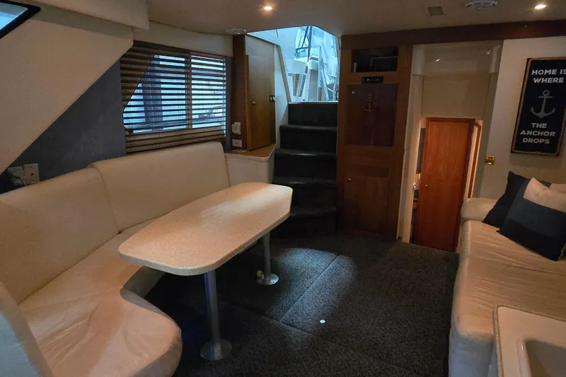 Slide: The Image of Interior of 1998 Silverton 322 Motor Yacht with cozy seating and dining area. - 25