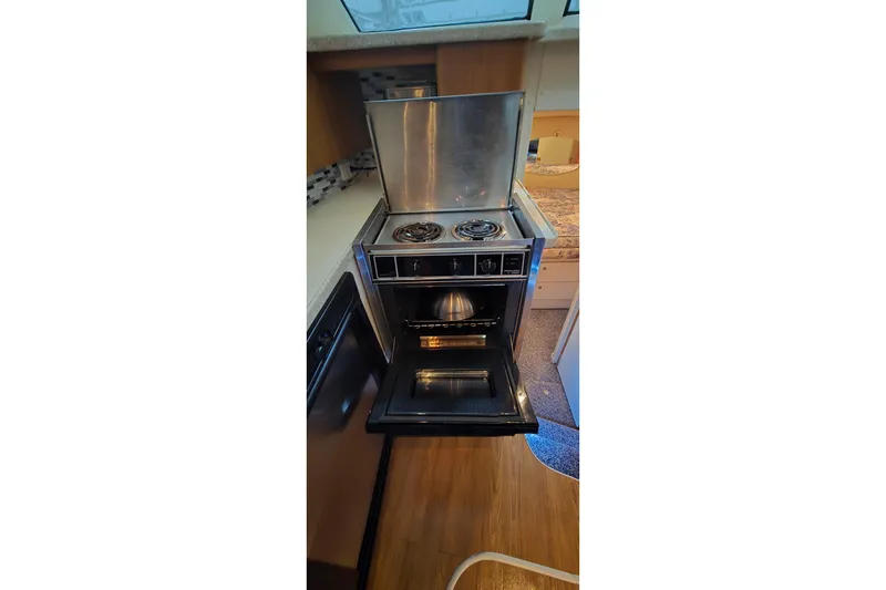 Slide: The Image of 1998 Silverton 322 Motor Yacht kitchen with stove and oven. - 27