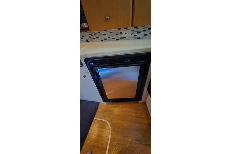 Slide: The Image of Compact kitchen area in 1998 Silverton 322 Motor Yacht with mini fridge. - 28