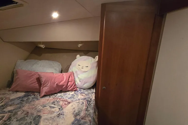 Slide: The Image of Cozy bedroom in 1998 Silverton 322 Motor Yacht with plush pillows and soft lighting. - 32