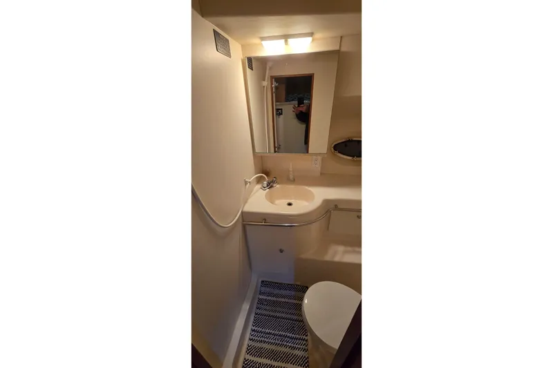 Slide: The Image of Bathroom interior of 1998 Silverton 322 Motor Yacht with sink and mirror. - 33