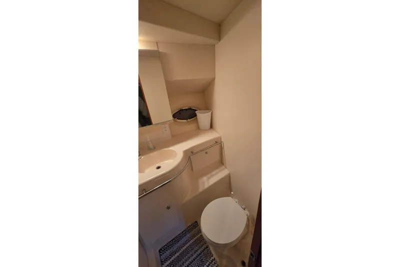 Slide: The Image of Bathroom interior of 1998 Silverton 322 Motor Yacht, featuring sink and toilet. - 34