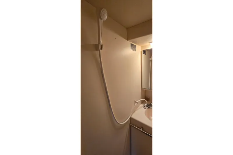 Slide: The Image of Shower area in 1998 Silverton 322 Motor Yacht bathroom, featuring a handheld showerhead. - 35