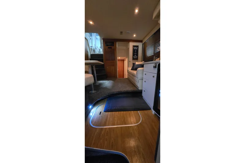 Slide: The Image of Interior of 1998 Silverton 322 Motor Yacht, featuring cozy seating and modern lighting. - 36