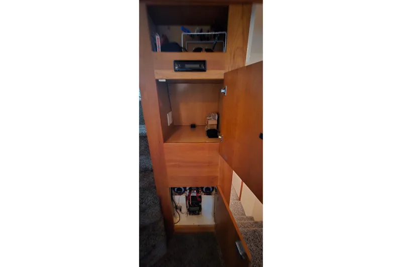 Slide: The Image of Interior storage compartments of a 1998 Silverton 322 Motor Yacht, showcasing wooden cabinetry. - 37