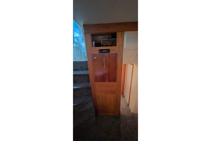 Slide: The Image of Interior of 1998 Silverton 322 Motor Yacht with wooden cabinetry and carpeted stairs. - 38