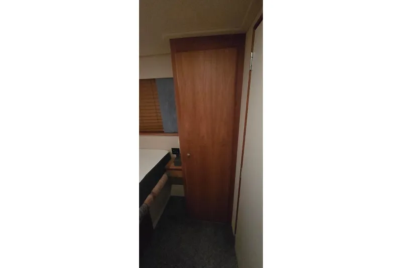 Slide: The Image of Interior of 1998 Silverton 322 Motor Yacht with wooden door and window blinds. - 40