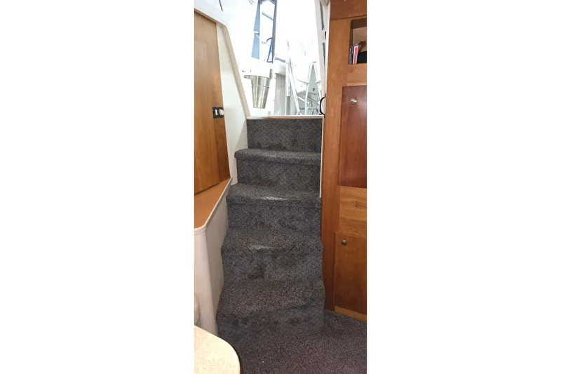 Slide: The Image of Carpeted stairs inside a 1998 Silverton 322 Motor Yacht, leading to the upper deck. - 43