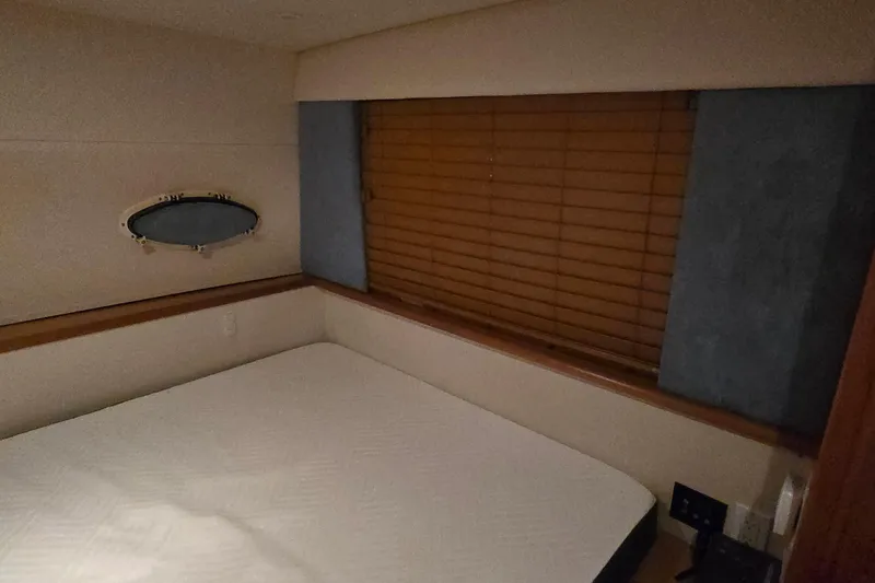 Slide: The Image of Interior cabin of 1998 Silverton 322 Motor Yacht with bed and window blinds. - 45