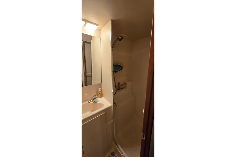 Slide: The Image of Bathroom interior of 1998 Silverton 322 Motor Yacht, featuring sink and shower area. - 47