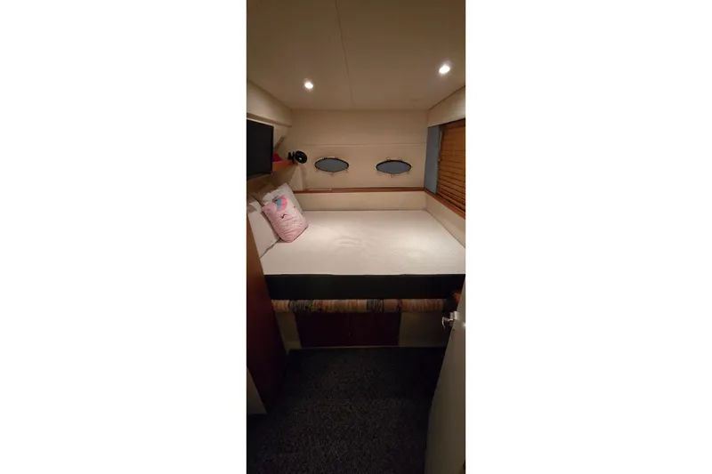 Slide: The Image of Cozy bedroom in 1998 Silverton 322 Motor Yacht with soft lighting and nautical decor. - 50