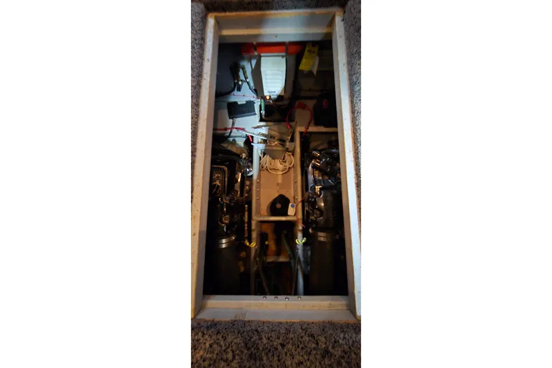 Slide: The Image of Engine compartment of a 1998 Silverton 322 Motor Yacht, showcasing mechanical components. - 52
