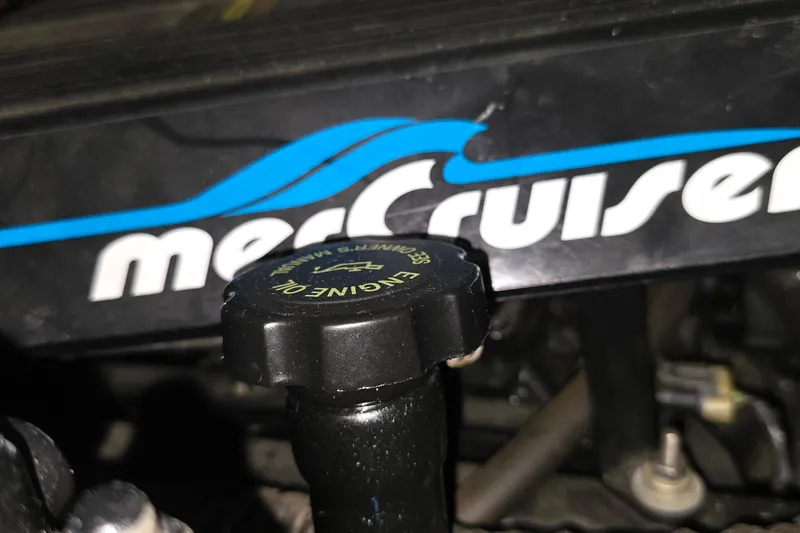 Slide: The Image of Engine oil cap on a 1998 Silverton 322 Motor Yacht with MerCruiser branding. - 56