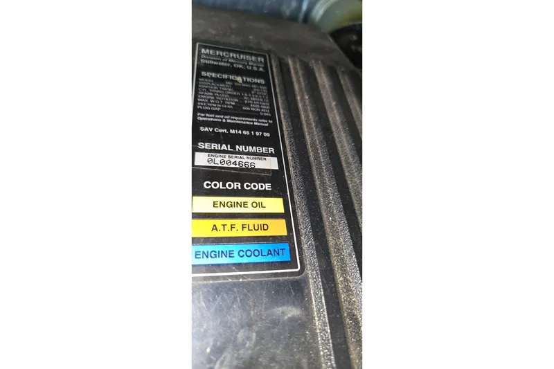 Slide: The Image of Label on MerCruiser engine with serial number and color codes for fluids. - 57