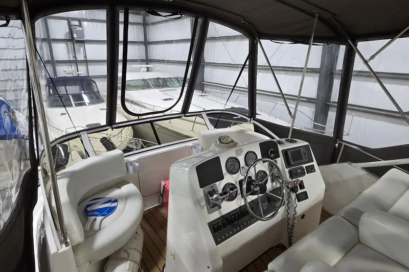 Slide: The Image of 1998 Silverton 322 Motor Yacht interior with helm, steering wheel, and navigation instruments. - 7