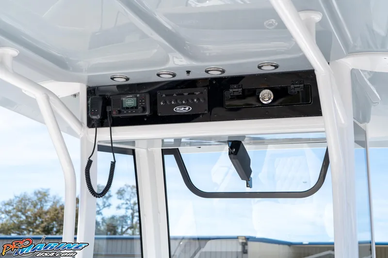 Slide: The Image of 2026 Sea Hunt Ultra 265 SE boat console with radio and controls. - 18