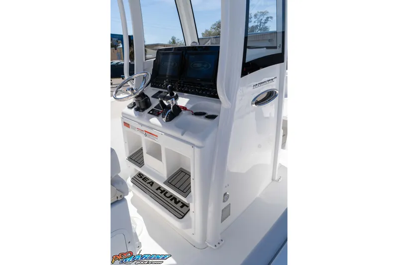Slide: The Image of 2026 Sea Hunt Ultra 265 SE boat console with steering wheel and controls. - 19