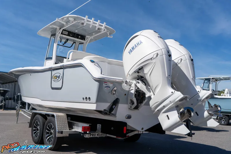 Slide: The Image of 2026 Sea Hunt Ultra 265 SE boat with dual Yamaha engines on a trailer. - 2