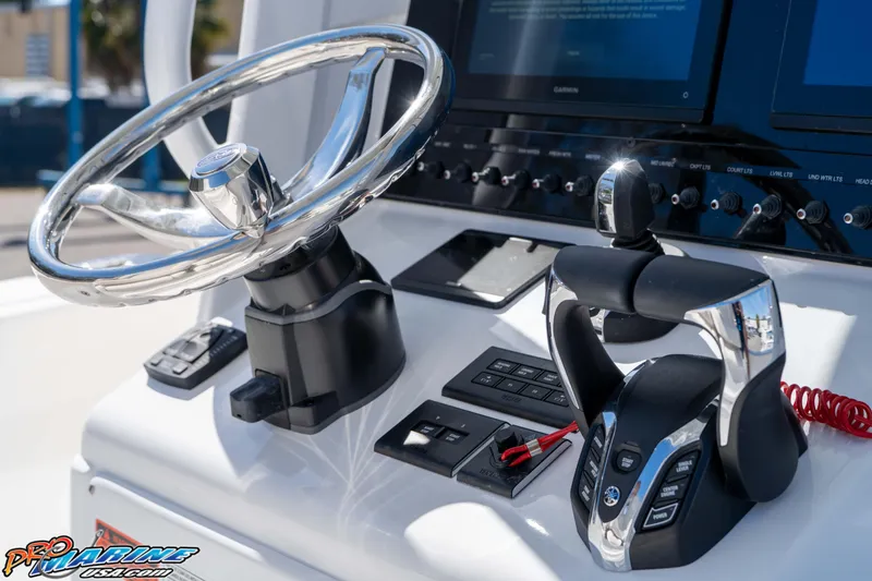 Slide: The Image of Steering console of 2026 Sea Hunt Ultra 265 SE boat with modern controls and displays. - 21