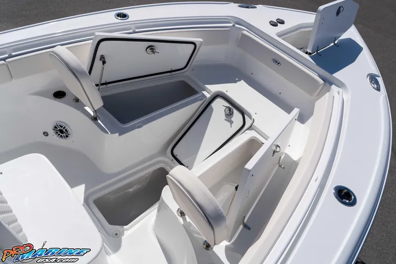 Slide: The Image of 2026 Sea Hunt Ultra 265 SE boat with open storage compartments and seating. - 25