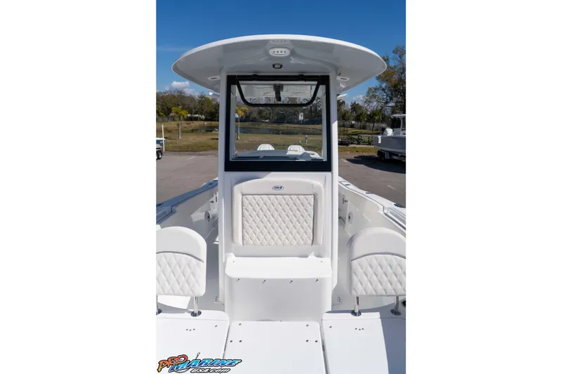 Slide: The Image of 2026 Sea Hunt Ultra 265 SE boat interior with white seating and console. - 26