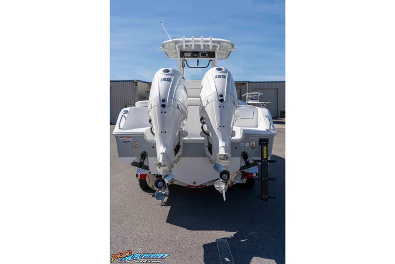 Slide: The Image of 2026 Sea Hunt Ultra 265 SE boat with dual outboard engines, rear view. - 3