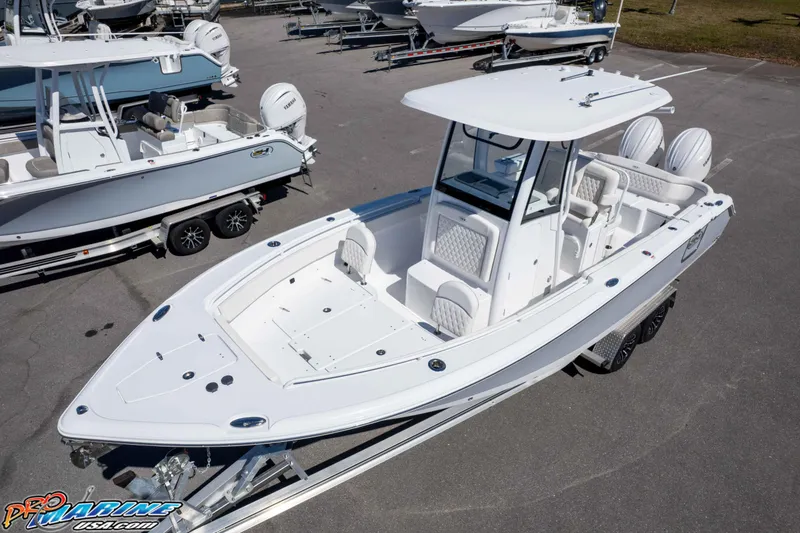 Slide: The Image of 2026 Sea Hunt Ultra 265 SE boat on trailer, displayed in a marina setting. - 35