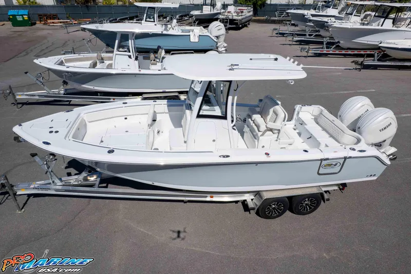 Slide: The Image of 2026 Sea Hunt Ultra 265 SE boat on trailer, featuring dual Yamaha engines. - 36