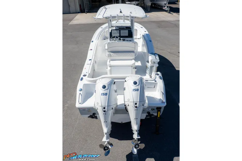 Slide: The Image of 2026 Sea Hunt Ultra 265 SE boat with dual 150 horsepower engines, docked outdoors. - 41